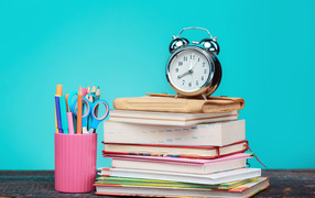 Alarm clock, books and stationery for school