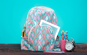 Backpack, alarm clock and stationery for school