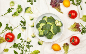 Broccoli on the table with tomatoes and herbs