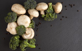 Champignons with broccoli on a gray table