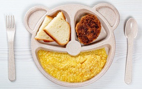Porridge, bread and cutlet for a child