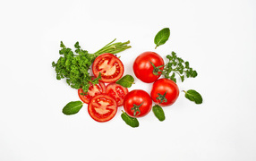 Red tomatoes with parsley on a white background