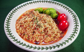 Vermicelli with sauce in a plate with tomatoes