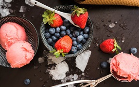 Balls of strawberry ice cream with blueberries and strawberries