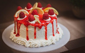 Beautiful white cake with raspberries and lemon