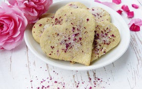 Heart shaped shortbread cookies in a white plate with flowers