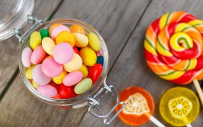 Multicolored lollipops in a jar on the table