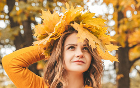 Beautiful girl with a wreath of leaves on her head