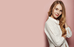 Girl in a white shirt on a pink background