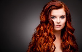 Long bright red hair of a beautiful girl