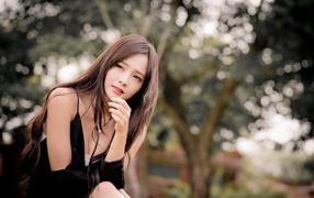 Pensive asian girl in black dress