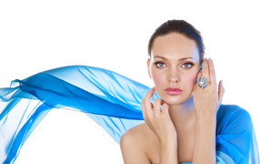 Real girl in a blue cape on a white background