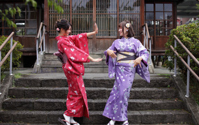Two beautiful Asian girls in kimono on the steps