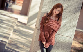 Young asian girl in brown sweater