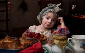 Girl with pancakes and treats for Shrovetide