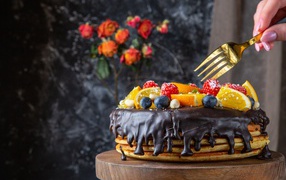 Pancake cake with chocolate and berries for Shrovetide