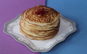 Ruddy pancakes with berries on the table for Shrovetide