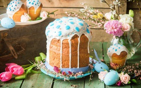 Beautiful Easter cake with white icing on a table with flowers