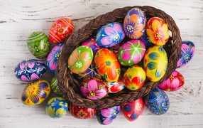 Beautiful painted eggs in a basket on a table for the holiday of Great Easter