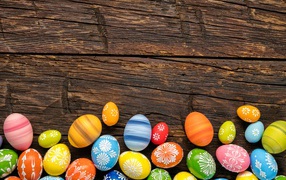 Multicolored easter eggs on a wooden table