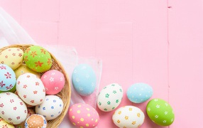 Multicolored easter eggs on pink background