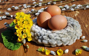 Three eggs with yellow flowers and pussy willow
