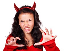 Girl devil on a white background in a Halloween costume