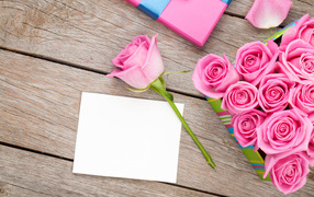 Bouquet of pink roses and a sheet of paper background for a postcard on March 8