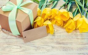 Yellow tulips and a gift for your beloved on March 8