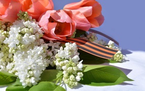 Bouquet of lilacs and tulips with St.George ribbon on May 9 Victory Day