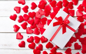 Gift and many red hearts on a white background for Valentine's Day
