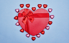 Red heart-shaped box with sweets for the beloved