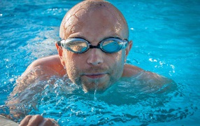 Male swimmer with glasses in the pool