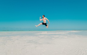 Satisfied man jumping in water on blue background