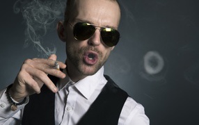Stylish man in glasses with a cigarette
