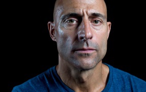 British actor Mark Strong on black background