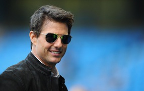 Smiling Tom Cruise with glasses