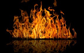 Hot fire is reflected in a black surface