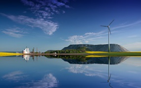 Wind turbine stands on the shore of the lake