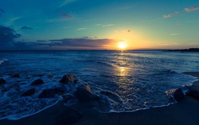 Beautiful sunset of the summer sun on the sea coast