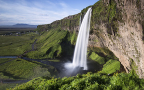 Seljalandsfoss fast waterfall flows down a cliff, Iceland