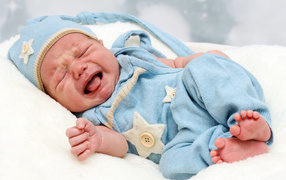 Crying nursing baby in a blue suit