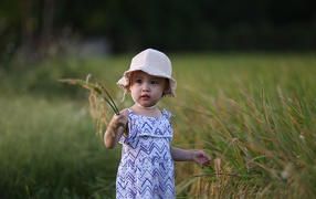 Little asian girl standing in the grass