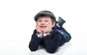 Little boy in a cap on a white background