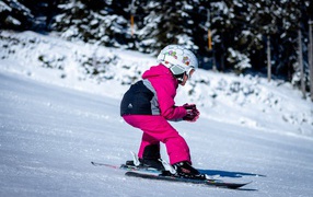 Little girl skiing in the snow