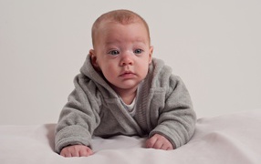Little newborn boy in gray suit