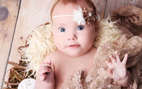 Удивленная голубоглазая новорожденная девочка 