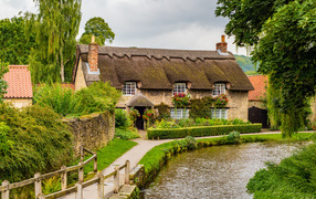 Beautiful old house by a water channel, England