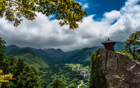 Beautiful view of the green-covered mountains under thick clouds, Japan