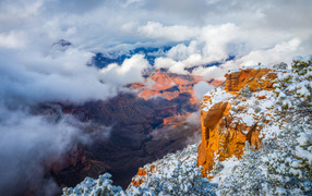 View of the Grand Canyon under white clouds, USA